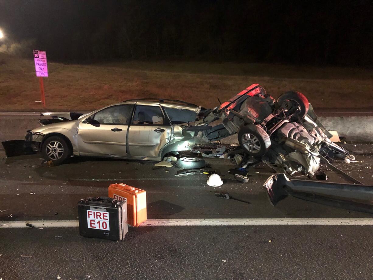 The mangled remains of a station wagon involved in a wrong way crash on state Highway 14 Sunday morning rests in the roadway. Two drivers were hospitalized with what firefighters described as relatively minor injuries. Sean E. Seager, who allegedly caused the crash, faces several charges in Clark County District Court.