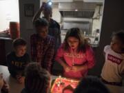 Levi Duncan, 6, from left, DJ Campbell, 9, Alexia Bautista-Matias-Cannon, 11, and Ryileigh Jones, 9, celebrate Alexia’s birthday Dec. 13. Alexia’s mom, Paige Magana, takes a photo behind them. Magana said she wanted to make sure Alexia had a special birthday, especially since they live in a shelter. “Just to let her know that she is special and she does have people that are important,” Magana said.