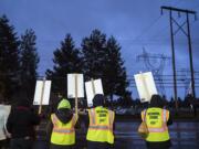 Supporters of the Vancouver Association of Education Support Professionals line the road during a Dec. 11 rally in front of the Vancouver Public Schools offices.