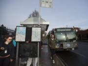 Kourtney Foley of Vancouver, left, joins fellow C-Tran riders as she makes her way off a bus in downtown Vancouver. Passengers can pay their fares in a variety of ways, but no change is given.