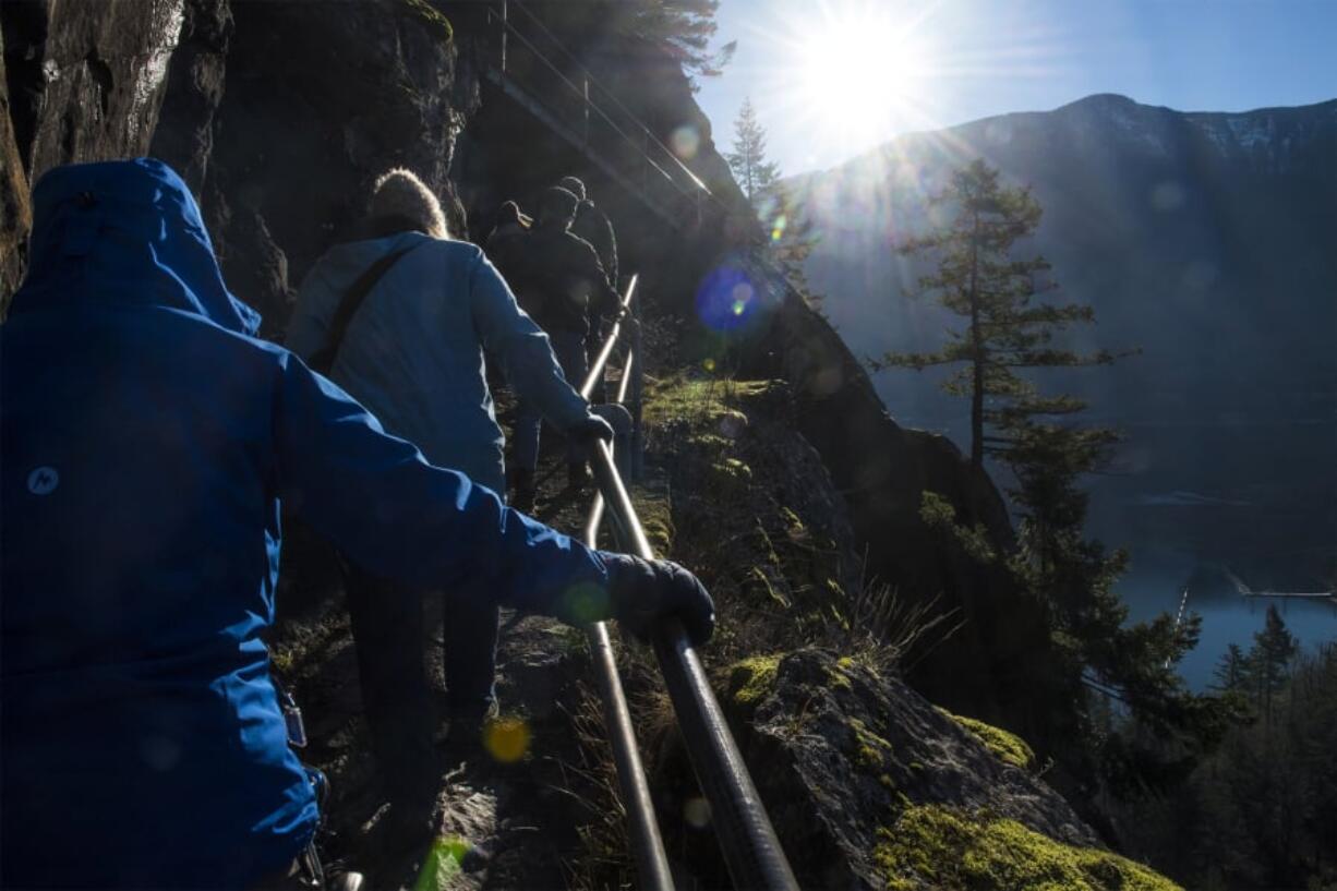 Hikers climb above the Columbia River Gorge during the Washington State Parks First Day Hike event at Beacon Rock State Park on Tuesday morning. About 30 participated in this year’s trek up Beacon Rock.