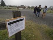 An informational message Monday morning at the Fort Vancouver National Historic Site informs visitors such as Angie and Enrique Perez of Arizona, from left, and longtime friend Andrew Filipczak of Vancouver, of the closure at the park because of the federal government shutdown. Site workers were among those furloughed Dec. 21.