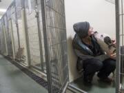 Animal care technician Tiarie West of La Center greets Dasher, a 4-year-old American pit bull, while feeding the animals at the Humane Society for Southwest Washington. The humane society wrapped up a banner year for adoptions in 2018, helping a total of 5,202 animals find homes.