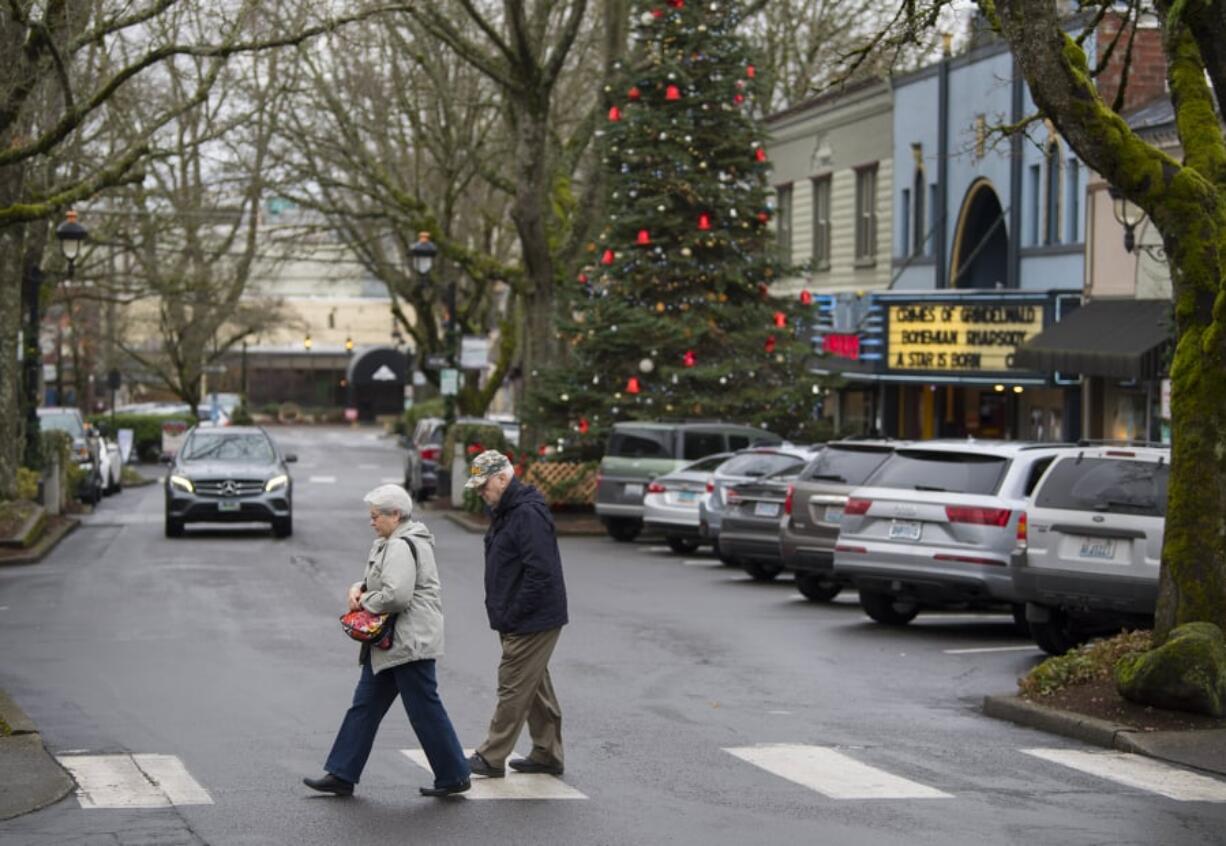 Camas residents Maria and Joe Wiles cross the street to stop for a cup of coffee while strolling through downtown Camas in January. On Tuesday the city was named as a finalist in the competition to be featured on the show “Small Business Revolution,” which would involve a makeover for some of the city’s downtown businesses.