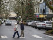 Camas residents Maria and Joe Wiles cross the street to stop for a cup of coffee while strolling through downtown Camas in January. On Tuesday the city was named as a finalist in the competition to be featured on the show “Small Business Revolution,” which would involve a makeover for some of the city’s downtown businesses.