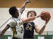 Evergreen's Mario Herring (24) jumps to block Kelso's Shaw Anderson (24) during Tuesday night's game at Evergreen High School in Vancouver on Jan. 8, 2019. Kelso won 79-74.