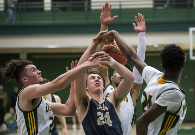 Evergreen's Carter Monda (23), Tyler Ricketts (5), and Mario Herring (24) surround Kelso's Shaw Anderson (24) as they fight for the ball during Tuesday night's game at Evergreen High School in Vancouver on Jan. 8, 2019. Kelso won 79-74.