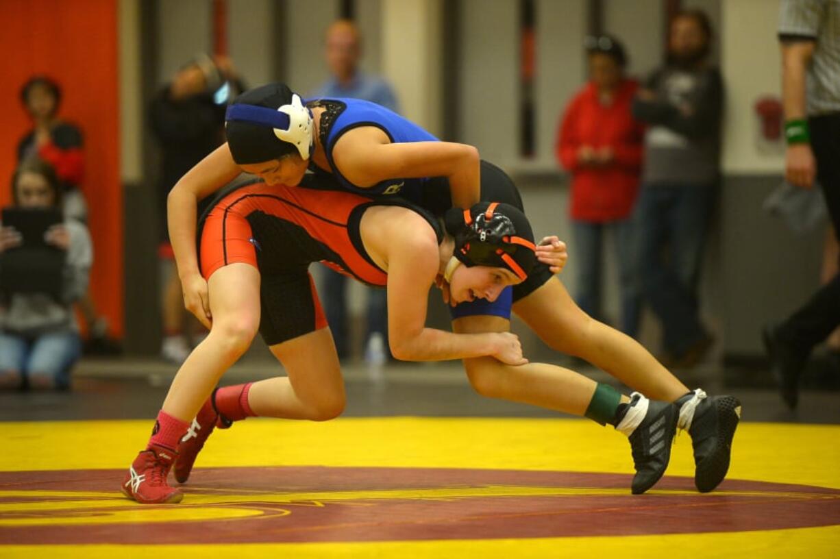 Washougal’s Emily Seekins wrestles La Center’s Jamie Osato in the 100-pound title match at the Clark County Championships at Battle Ground High School on Saturday. Seekins won by pin to help the Panthers capture the girls team title.