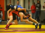 Washougal’s Emily Seekins wrestles La Center’s Jamie Osato in the 100-pound title match at the Clark County Championships at Battle Ground High School on Saturday. Seekins won by pin to help the Panthers capture the girls team title.