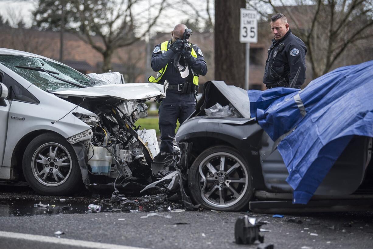 Vancouver Police investigators survey the scene of and crash on Northeast 136th Avenue in East Vancouver on Wednesday morning, Jan. 9, 2019.