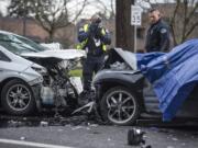 Vancouver Police investigators survey the scene of and crash on Northeast 136th Avenue in East Vancouver on Wednesday morning, Jan. 9, 2019.