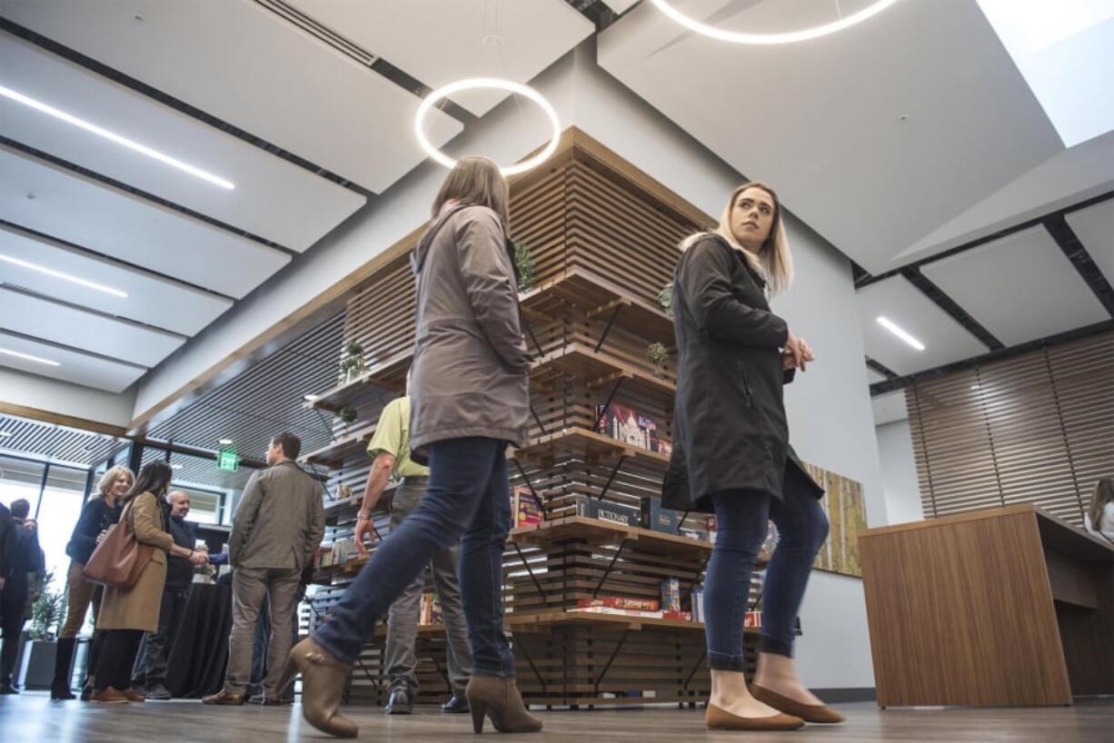 Laura Yoccabel-Dibble, left, and Haylie Huffman, of the Heathman Lodge, explore the new Vancouver Clinic, which has books and board games on shelves. The clinic will provide opportunities for socializing.