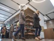 Laura Yoccabel-Dibble, left, and Haylie Huffman, of the Heathman Lodge, explore the new Vancouver Clinic, which has books and board games on shelves. The clinic will provide opportunities for socializing.