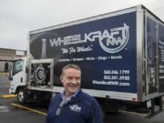 Pat Heffron, owner of WheelKraft NW, stands in front of one of the company’s 10 mobile service trucks that travel to customers and car dealerships for wheel repairs.