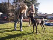 Lynn Goss and her daughter Maddison, 12, of Vancouver play Sunday with their newly adopted service dog Hooch, also pictured at top, who was previously Robert Scott McCubbins’ dog until McCubbins passed away in November.