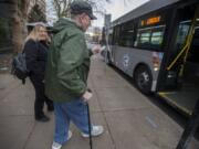 Veronica Marti, lead travel trainer for C-Tran, left, joins Vancouver resident John Prince as he catches a ride home Tuesday afternoon, Jan. 15, 2019.