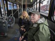 Vancouver resident John Prince, front, catches a ride downtown on the bus Tuesday with Veronica Marti, lead travel trainer for C-Tran. The Clark County Commission on Aging is recommending that the county improve connectivity for seniors.