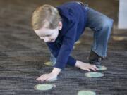 Henry Grice, 5, walks like a deer at the Second Saturday “Mammals of the Columbia” event at Vancouver’s Water Resources Education Center on Saturday. Grice was accompanied by his dad, Corey. They are from Portland. (Randy L.