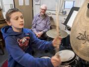 D.J. Trussler, 12, plays “The Shortest Straw” by Metallica on the drums while Jim Pitts, drum instructor at the Opus School of Music, watches during a lesson at the Ridgefield location, 414 Pioneer St.