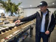 Jacobson Salt Co. founder Ben Jacobsen shows off some of his favorite infused salts at the company’s shop and event space in Portland. Some of the infused salts partner with other local companies like the Infused Stumptown Hair Bender Salt.