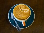 A freshly brewed cappuccino sits on the counter at Compass Coffee in downtown Vancouver.