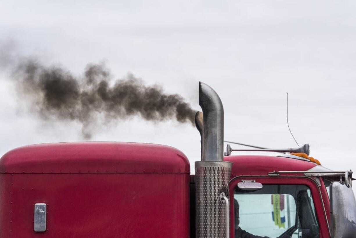 Exhaust pours out of a semi-truck as it leaves the Port of Vancouver on Friday. Areas near the port score poorly in a study that ranks health risks caused by environmental quality.