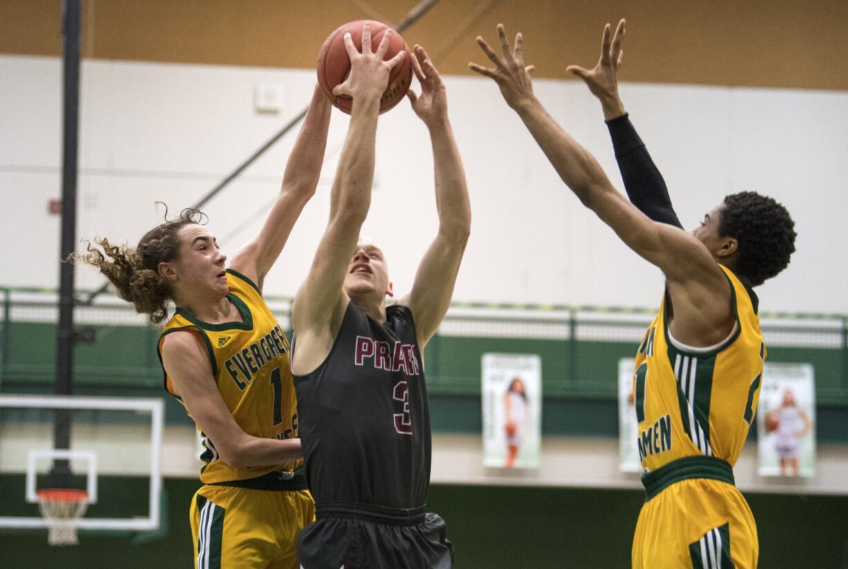 Evergreen's Jaden Stanley (1) and Isaiah Enyinwa (21) jump to block Prairie's Kameron Osborn (3) during Friday night's game on Jan. 18, 2019. Prairie won 68-56.