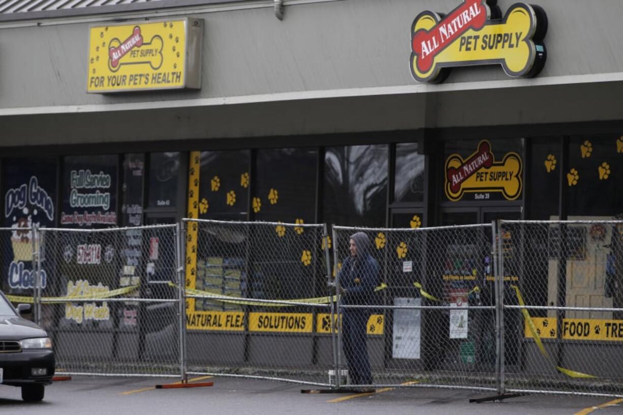 Businesses owners were kept from their stores Sunday after a three-alarm fire Saturday did heavy damage to the Holly Park Shopping Center. Fire restoration experts worked to secure the structure after the roof partially collapsed.