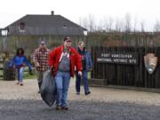 The Sudbeck family of Camas, left to right, Kat, Kevin, James and Helen, collect trash at Fort Vancouver National Historic Site. They were one of two groups out picking up garbage at Fort Vancouver on Saturday due to the partial government shutdown.