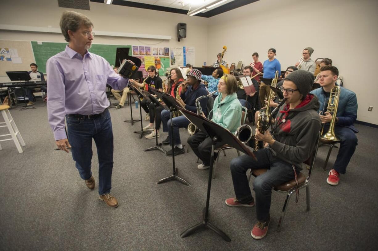 Dr. Doug Harris carries an electronic tuner while members of the Clark College Jazz Band tune up their instruments before beginning rehearsal on a recent Friday afternoon. Left: They still play the classics. During rehearsal on a recent Friday afternoon, the Clark College Jazz Band worked on “Fly Me To The Moon,” a song first released in 1954.