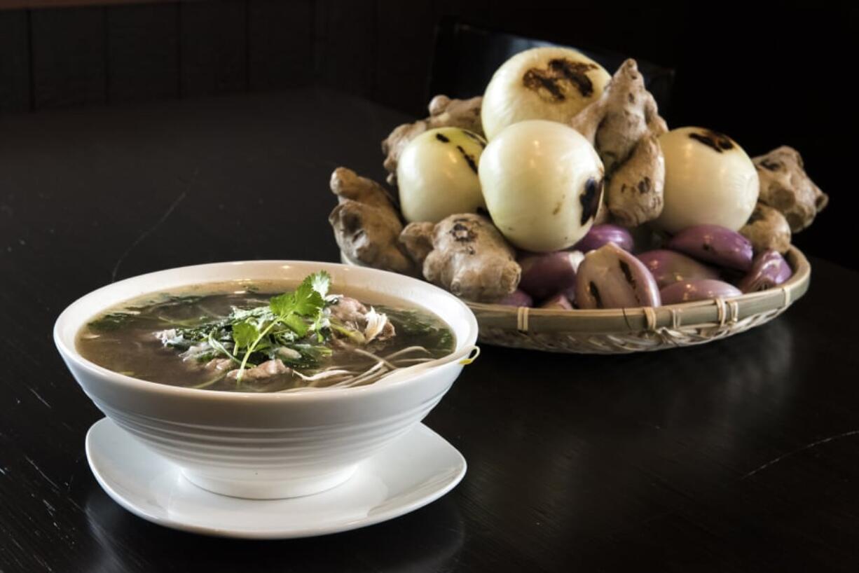 The eye round steak pho, paired here with charred onions, shallots and ginger used to create the broth, is among the offerings at Dop Pho.