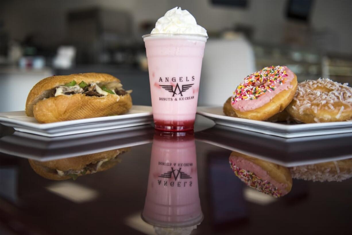 The Philly Cheesesteak, from left, a cherry Italian soda and fresh doughnuts at Angel’s Donuts & Ice Cream.