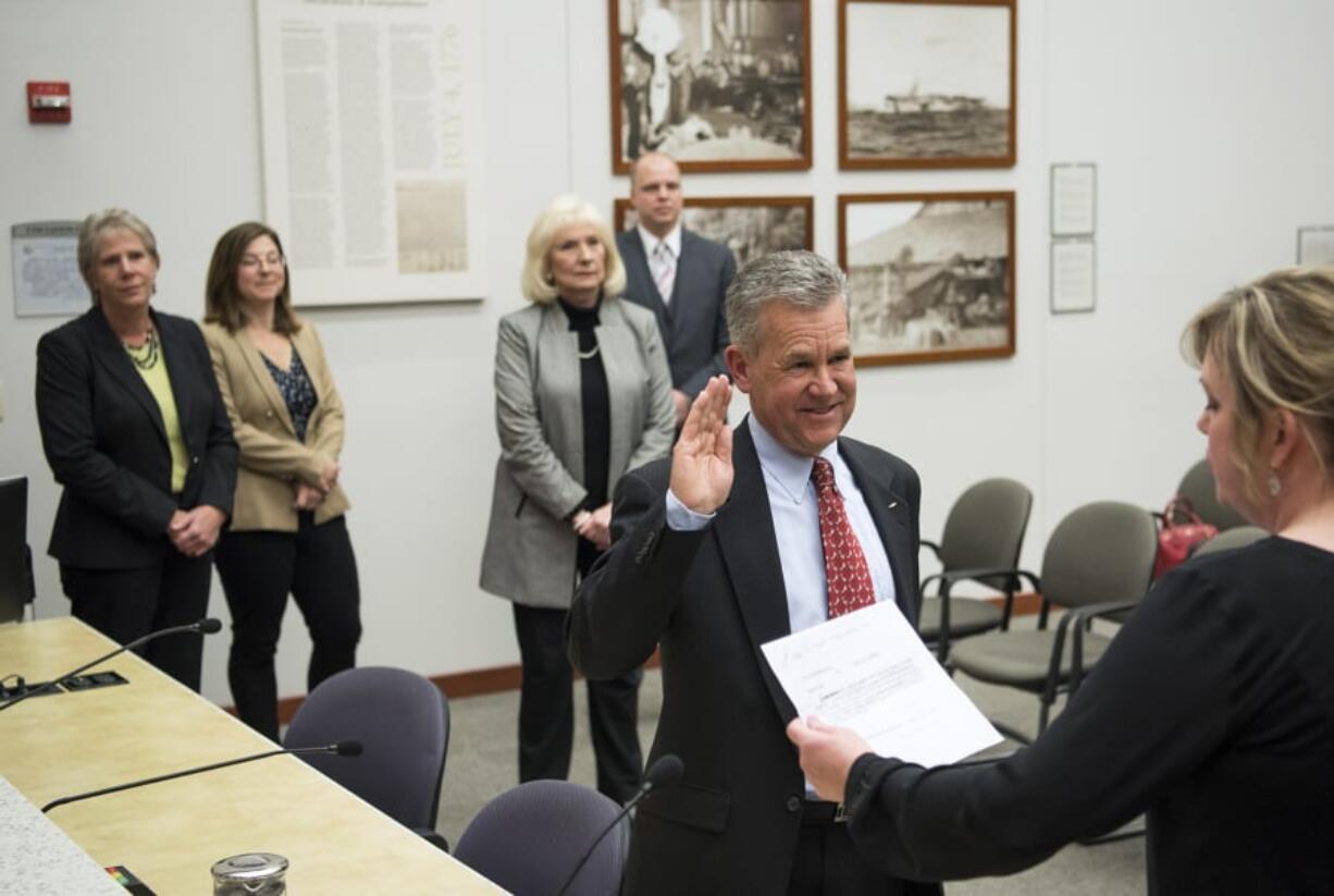 The Clark County Council watches Gary Medvigy take his oath of office after being appointed the newest member of the council Tuesday at the Public Service Center.