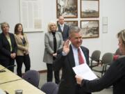 The Clark County Council watches Gary Medvigy take his oath of office after being appointed the newest member of the council Tuesday at the Public Service Center.