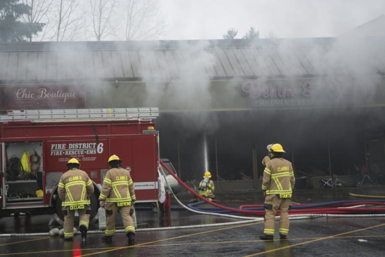 Firefighters from Fire District 6, Vancouver Fire Department and Clark County Fire and Rescue responded to the three-alarm fire Saturday at Holly Park Shopping Center in Hazel Dell.