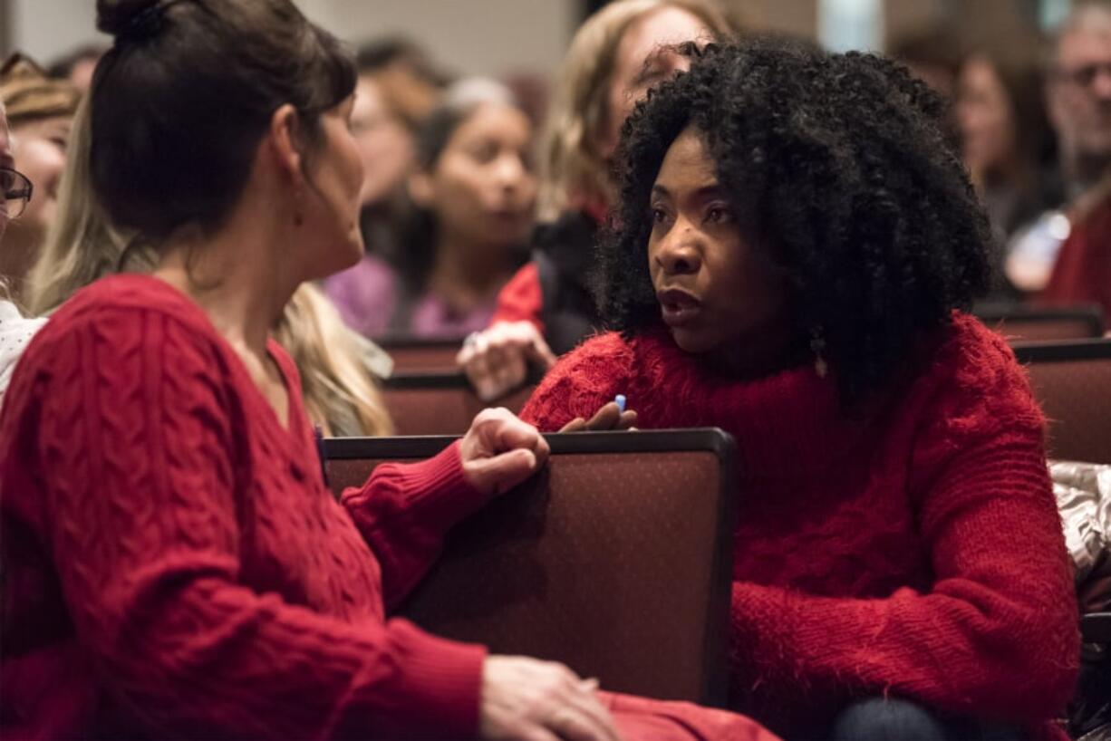 Jamie Carstensen, a paraeducator at Hudson’s Bay High School, left, speaks with Chipo Sowards, a library Clerk at Hudson’s Bay High School, shortly before a strike vote during a Vancouver Association of Educational Support Professionals meeting on Tuesday night. The VAESP represents more than 700 classified staff, including paraeducators, clerks and secretaries.