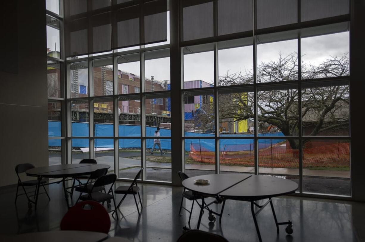 A student walks past current construction at Ridgefield High School funded in the 2017 bond.