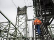 Interstate 5 Bridge Supervisor Marc Gross, with the Oregon Department of Transportation, climbs a ladder leading to the bridge’s machine room during a tour on Thursday morning.