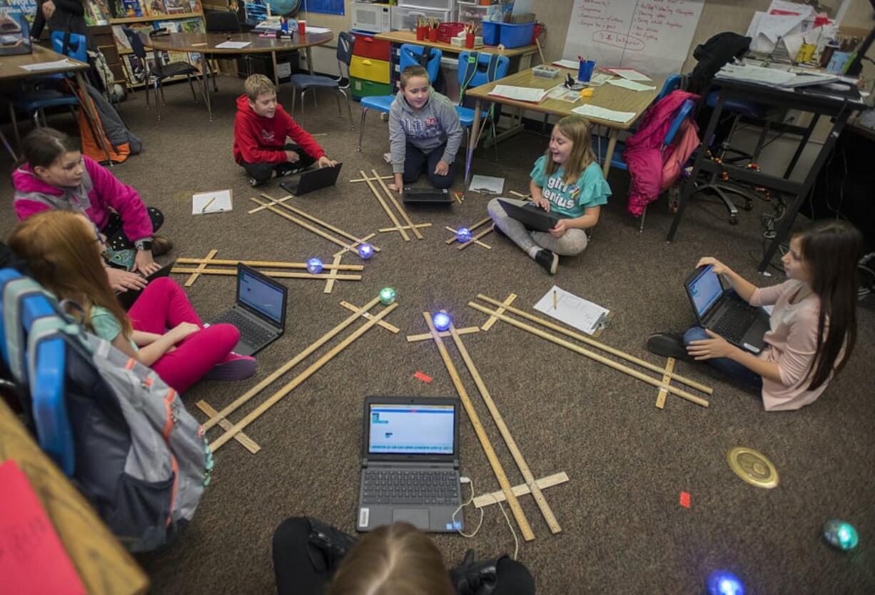 Fourth-graders at Silver Star Elementary School react as they test out their Sphero robots during science class. These Sphero robots are funded by local levy dollars, and it appears voters have approved Evergreen Public Schools levy requests to continue this and other programs.