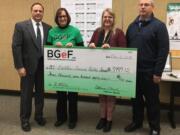 Battle Ground: Battle Ground Public Schools Superintendent Mark Ross, from left, accepts a check to purchase two automated external defibrillators from Battle Ground Education Foundation President Colleen O’Neal, CAM Academy Assistant Principal Julie Williamson and Mitch Thompson, the district’s director of business and risk management.