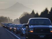 The outline of Mount Hood rises behind westbound morning traffic on state Highway 14 near the intersection of Interstate 205 on Tuesday. A $25 million state project will seek to reduce congestion by widening the freeway.