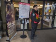 A hospital security worker, who declined to be identified, stands at a door at PeaceHealth Southwest Medical Center in Vancouver while screening for visitors under 12 years old and those who have not been vaccinated for measles as part of the hospital’s measles outbreak protocol. Children, especially kids under 5, are especially vulnerable to contracting measles.