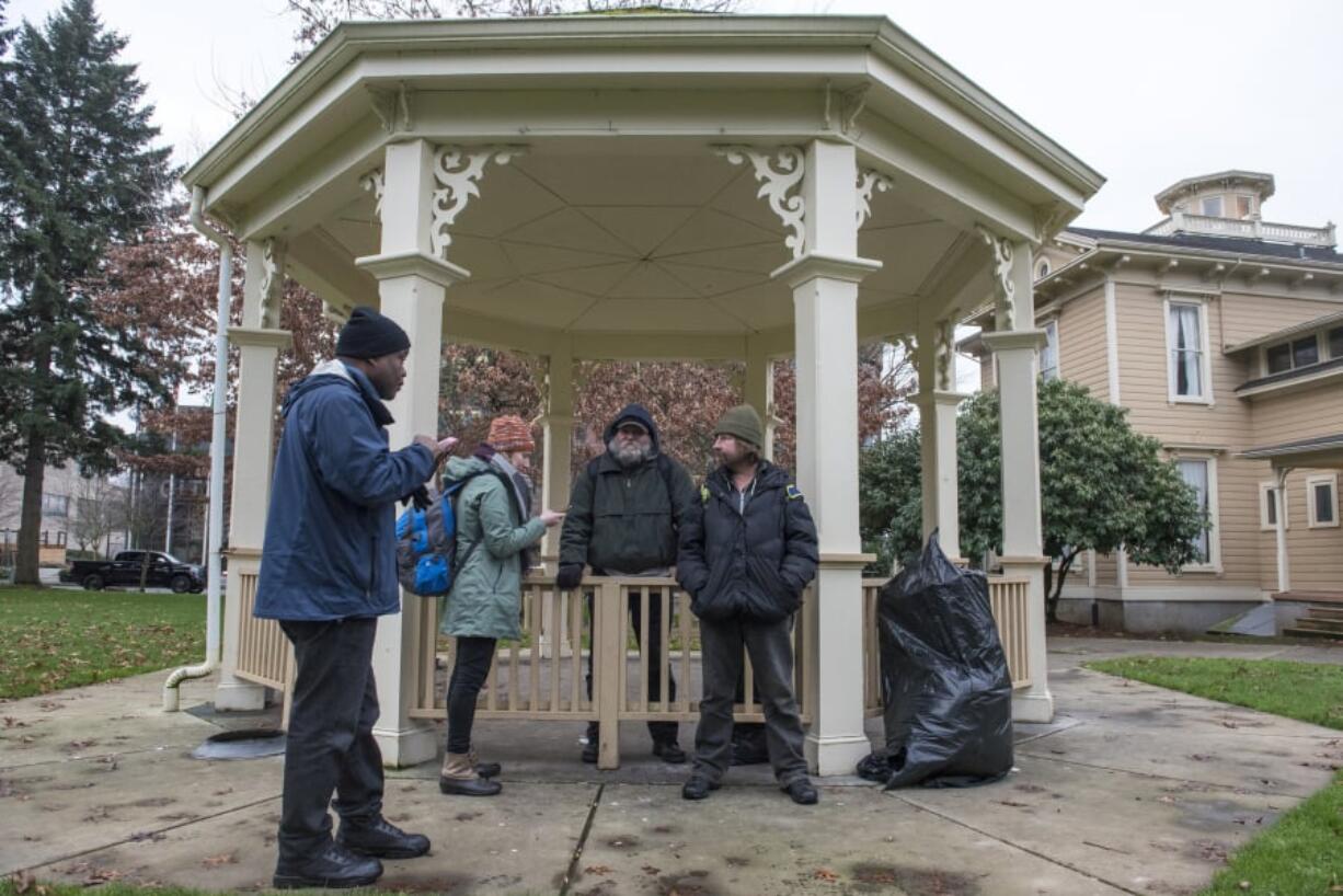 Willie Hurst, from left, and Katelyn Benhoff, case managers with Share, speak with Mitch and Patrick S., who declined to provide their last names, for the annual Point in Time count in January. The count provides a single-day snapshot of homelessness.