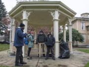 Willie Hurst, from left, and Katelyn Benhoff, case managers with Share, speak with Mitch and Patrick S., who declined to provide their last names, for the annual Point in Time count in January. The count provides a single-day snapshot of homelessness.