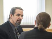 Ronald Jay Bianchi, left, speaks with one of his attorneys, Whitney Hawke of Vancouver Defenders, before the start of his trial Monday morning in Clark County Superior Court. Prosecutors filed amended charges against Bianchi after the Washington Court of Appeals in 2017 vacated three of his convictions tied to a 1997 Vancouver bank robbery.