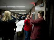 Members of the Vancouver Association of Educational Support Professionals voted Friday to ratify a three-year contract with Vancouver Public Schools. Yvette De La Cruz, center, Washington Education Association staff, shares high-fives as members leave the meeting.