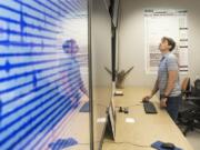 Seismologist Wes Thelen monitors data readouts in the operations room at the U.S. Geological Survey Cascades Volcano Observatory on Monday. Thelen worked part time without pay during the 35-day partial federal government shutdown, tracking seismic activity on Mount St. Helens and Mount Rainier.