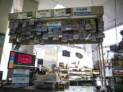 The counter display at the Bus Stop Market is adorned with winning lottery tickets. The store will close Feb. 15.