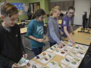 Washougal: Jemtegaard Middle School students, from left, Carson Kansler, Gracie Miller, Danica Stinchfield and Brooklyn Chase, play the Budget Game at an iQ Credit Union workshop for students in the Club 8 after-school program.