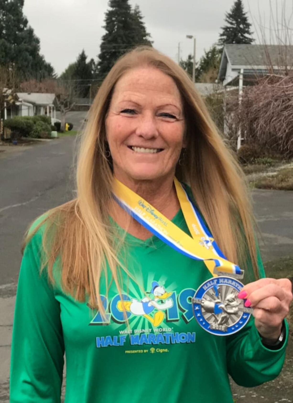 Central Vancouver: Diane Sprenger, 60, received this medal for running a half-marathon at Disney World in Florida. She has more than 30 medals for running races.